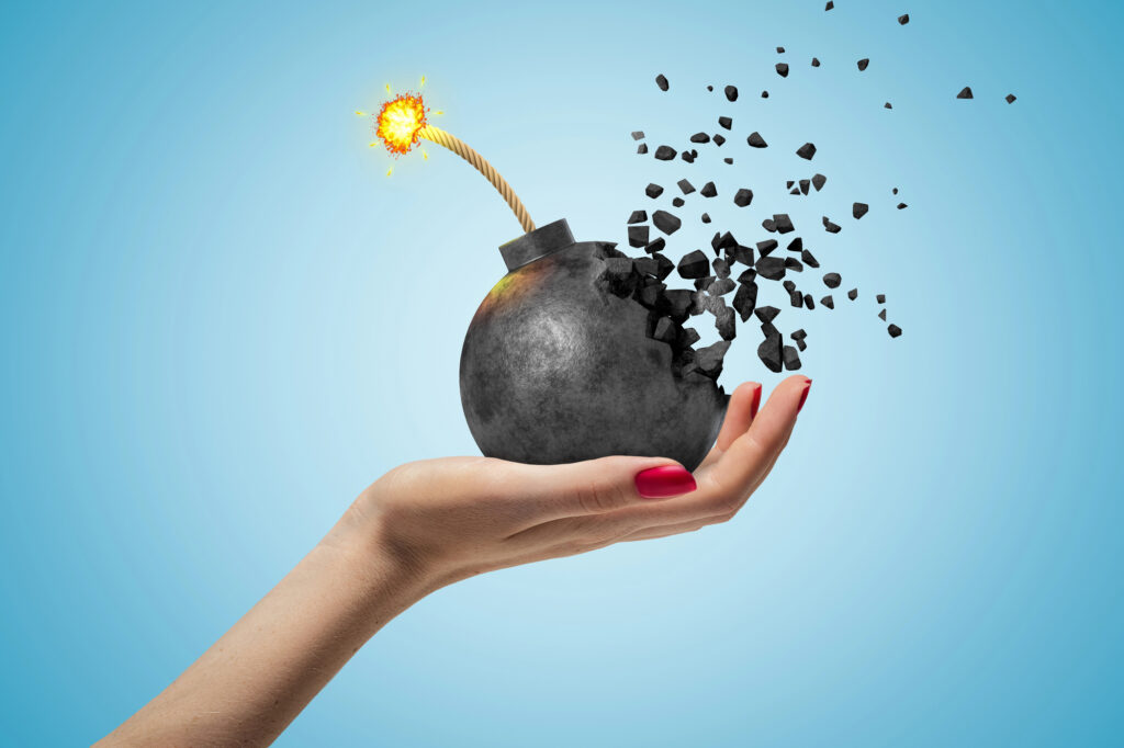 a hand holding a bomb